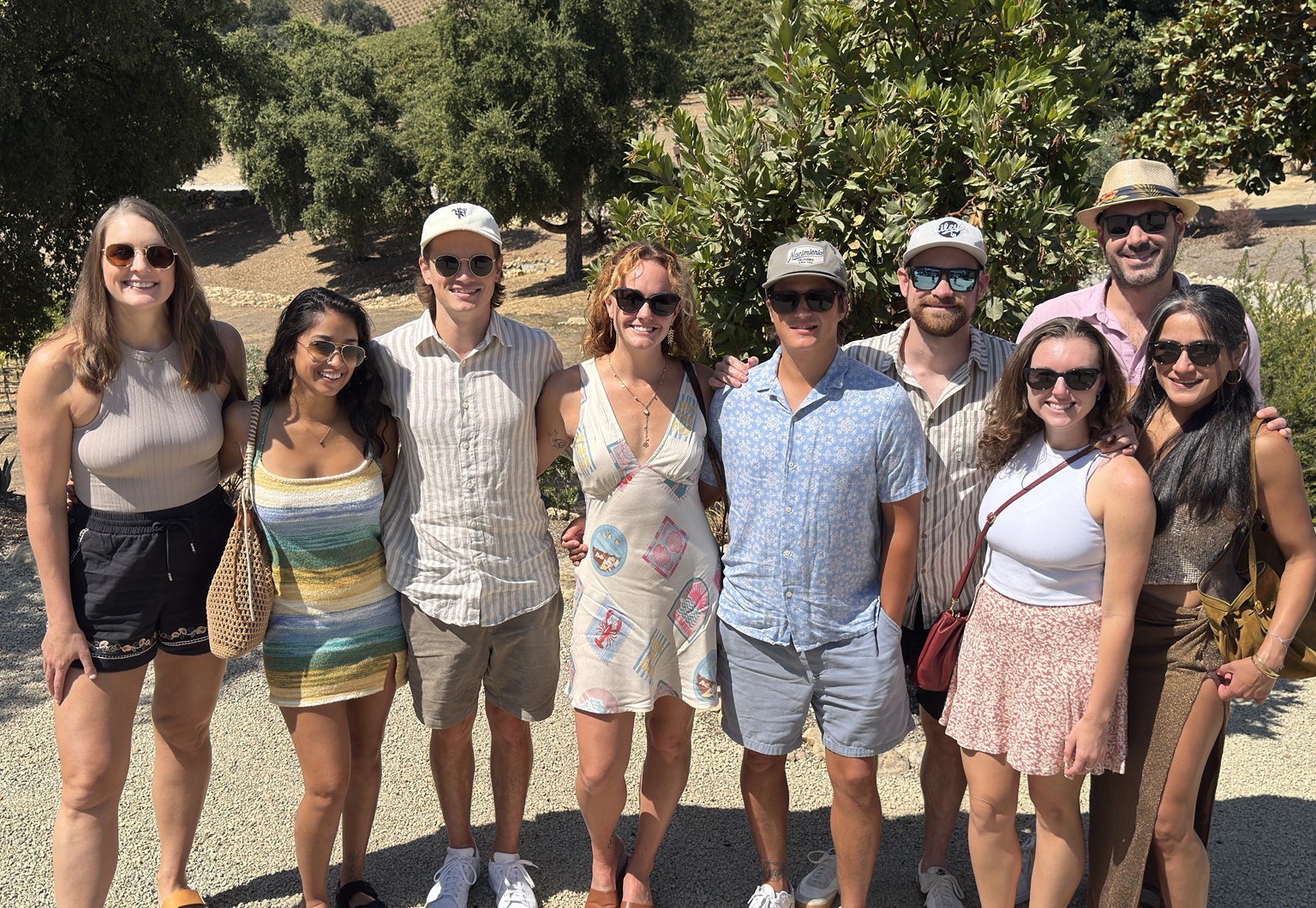 Wine tour group smiling together outdoors at a Paso Robles winery